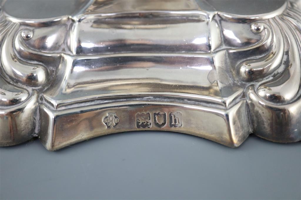 A pair of Edwardian silver candlesticks by William Hutton & Sons,